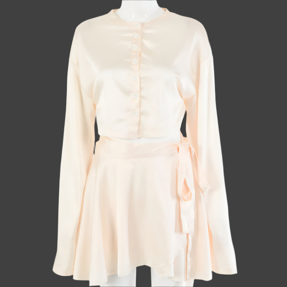 A model wearing a stylish two-piece set, featuring a high-waist tie skirt and a long-sleeved cardigan top, highlighting the flattering fit and elegant draping