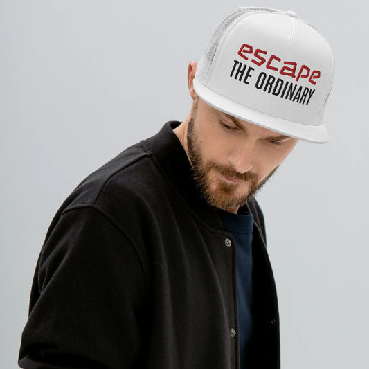 Green-brim trucker hat featuring a white front panel embroidered with ‘escape THE ORDINARY’ text in red and black, worn with a black jacket—stylish, bold, and perfect for casual street-style fashion.
