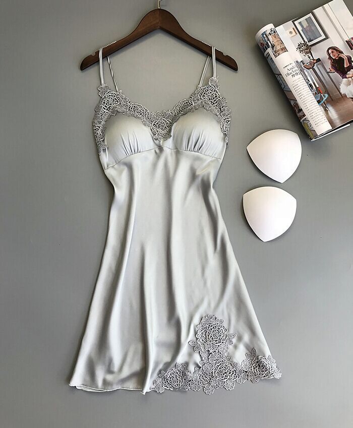 Sleeveless nightdress with lace detailing around the neckline and hem, displayed on a wooden hanger against a gray background—sexy, elegant, and perfect for homewear.