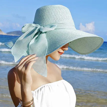 Elegant wide-brim sun hat with a bow detail, available in multiple colors including beige, black, white, pink, and blueâstylish, lightweight, and perfect for sunny days.