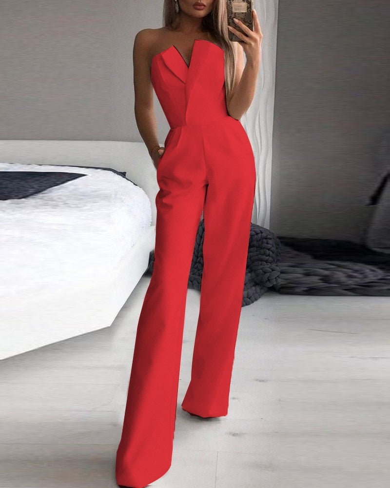 Stylish woman in a chic black strapless jumpsuit taking a mirror selfie, showcasing a sleek V-neckline and wide-leg silhouette—effortlessly elegant and modern.