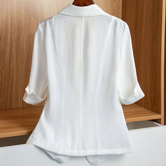 White tailored blazer with a single-button closure, structured shoulders, front flap pockets, and rolled-up sleeves—modern, elegant, and perfect for office or casual styling.