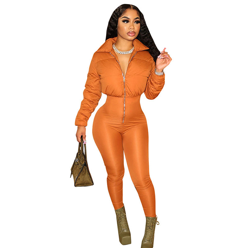 Statement puffer jumpsuit with front zipper closure, paired with green lace-up boots, chunky accessories, and a stylish handbag – bold, modern, and fashion-forward.