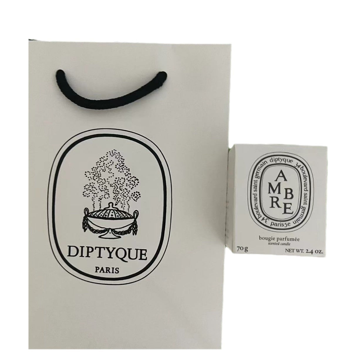Display of Diptyque candles in clear glass jars with white labels, showcasing 24 visible scents including Baies, Tubereuse, Patchouli, and Gardenia, arranged in rows with varied wax colours