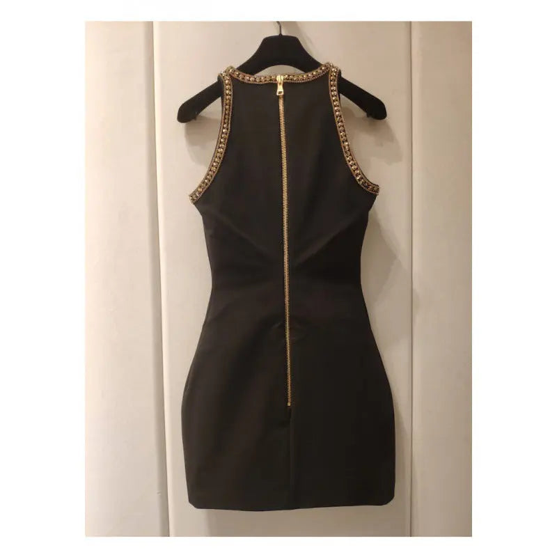 Black sleeveless mini dress with intricate gold sequins and fringe embellishments, styled for a glamorous evening look