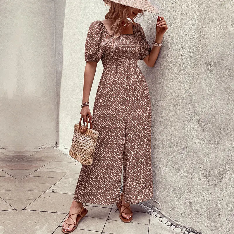 Elegant black floral jumpsuit with square neckline, puffed short sleeves, and wide-leg pants – stylish, breathable, and perfect for casual or chic occasions.