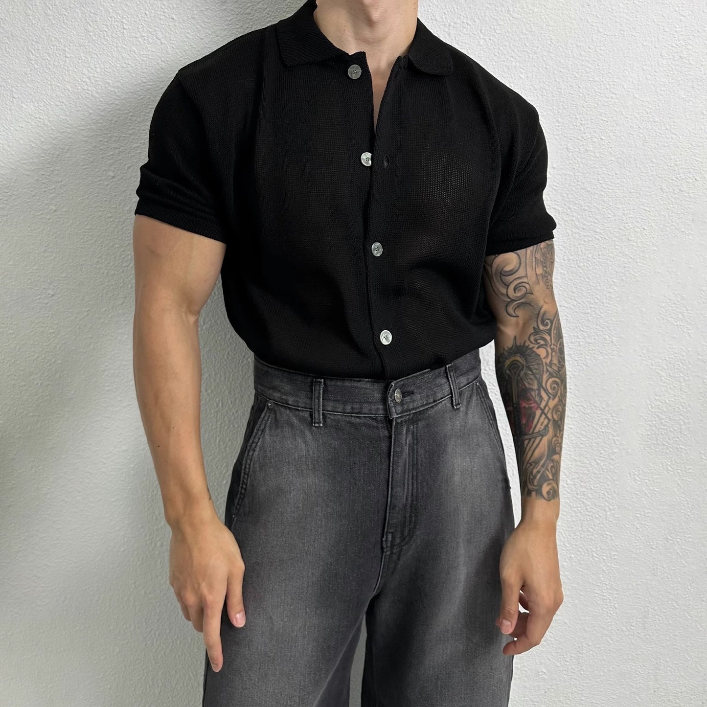 A men’s ribbed polo shirt in black and grey-blue, featuring a textured fabric and a sleek modern fit, ideal for smart-casual outfits.
