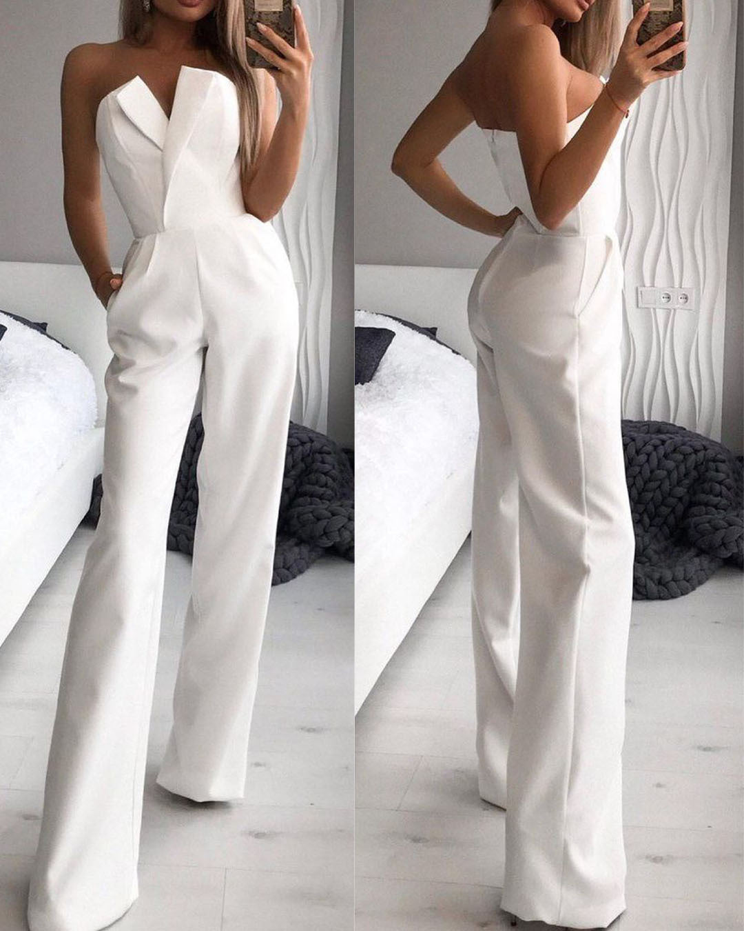 Stylish woman in a chic black strapless jumpsuit taking a mirror selfie, showcasing a sleek V-neckline and wide-leg silhouette—effortlessly elegant and modern.