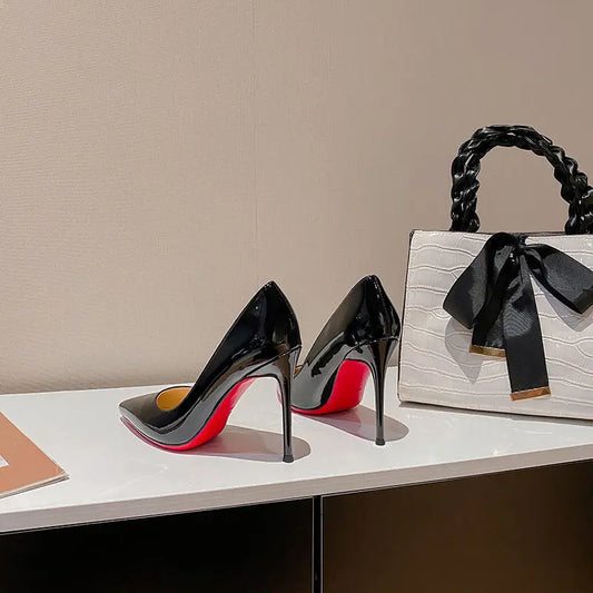 A bold, high-shine heel designed to command attention with timeless elegance.