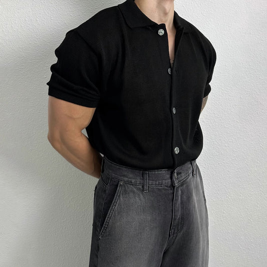 A men’s ribbed polo shirt in black and grey-blue, featuring a textured fabric and a sleek modern fit, ideal for smart-casual outfits.