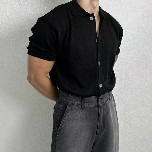 A men’s ribbed polo shirt in black and grey-blue, featuring a textured fabric and a sleek modern fit, ideal for smart-casual outfits.