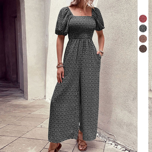 Elegant black floral jumpsuit with square neckline, puffed short sleeves, and wide-leg pants – stylish, breathable, and perfect for casual or chic occasions.