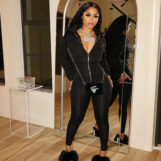 Statement puffer jumpsuit with front zipper closure, paired with green lace-up boots, chunky accessories, and a stylish handbag – bold, modern, and fashion-forward.