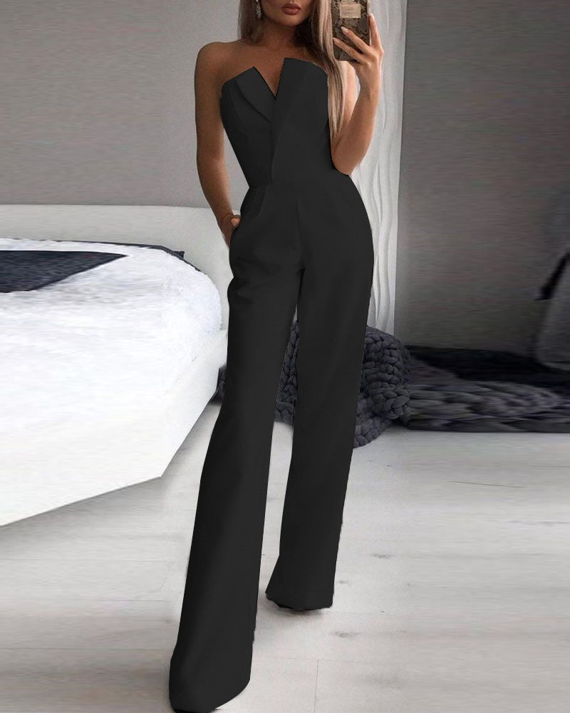 Stylish woman in a chic black strapless jumpsuit taking a mirror selfie, showcasing a sleek V-neckline and wide-leg silhouette—effortlessly elegant and modern.