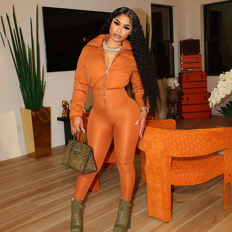 Statement puffer jumpsuit with front zipper closure, paired with green lace-up boots, chunky accessories, and a stylish handbag – bold, modern, and fashion-forward.