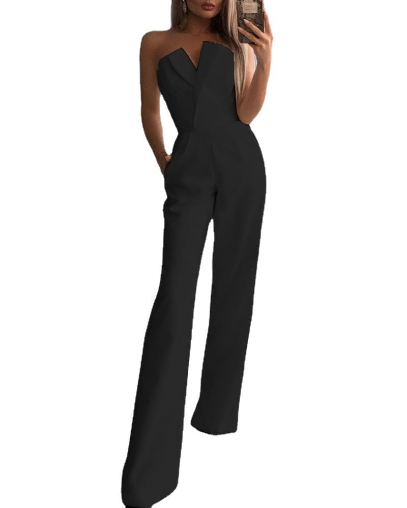 Stylish woman in a chic black strapless jumpsuit taking a mirror selfie, showcasing a sleek V-neckline and wide-leg silhouette—effortlessly elegant and modern.
