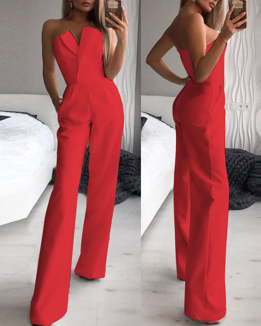 Stylish woman in a chic black strapless jumpsuit taking a mirror selfie, showcasing a sleek V-neckline and wide-leg silhouette—effortlessly elegant and modern.