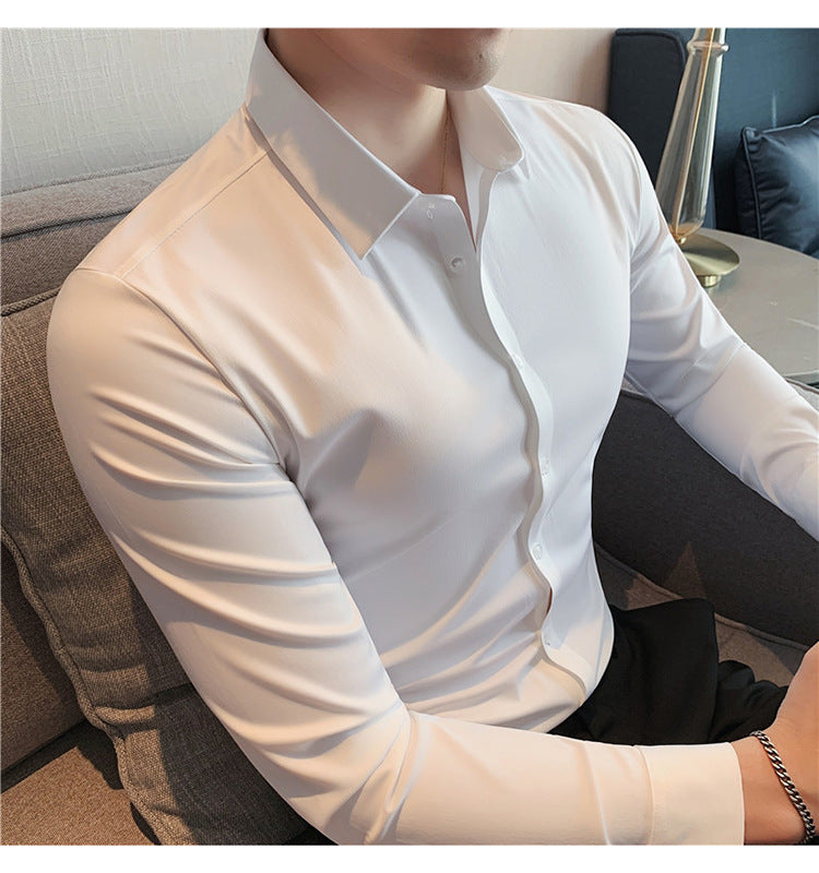 Premium stretch silk men’s long-sleeve button-up shirt in a solid white color, worn by a seated individual, showcasing smooth luxurious fabric and business-ready styling.