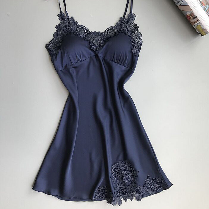 Sleeveless nightdress with lace detailing around the neckline and hem, displayed on a wooden hanger against a gray background—sexy, elegant, and perfect for homewear.