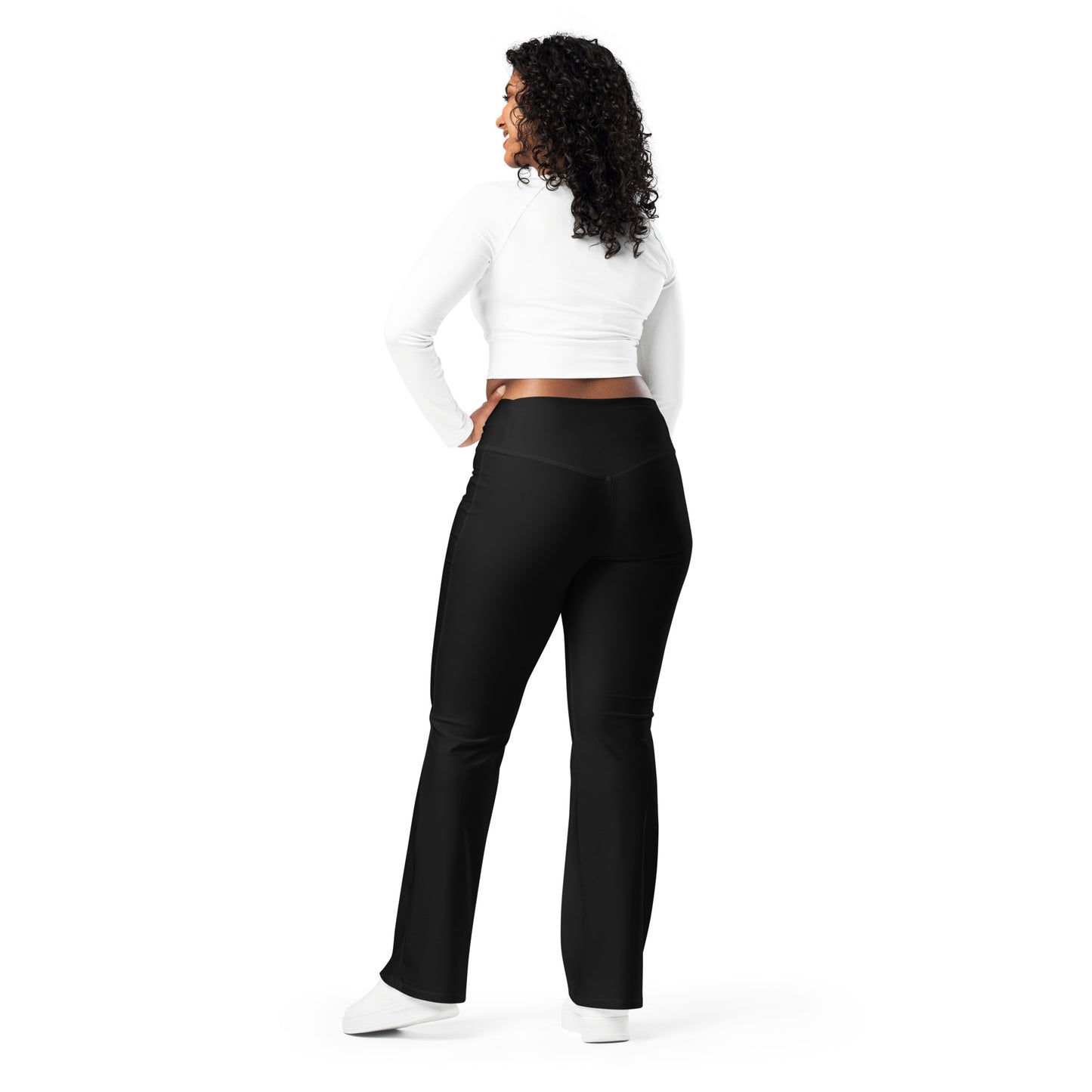 Person wearing black leggings paired with a beige crop top, white button-up jacket, and white sneakers—modern, stylish, and perfect for casual fashion.