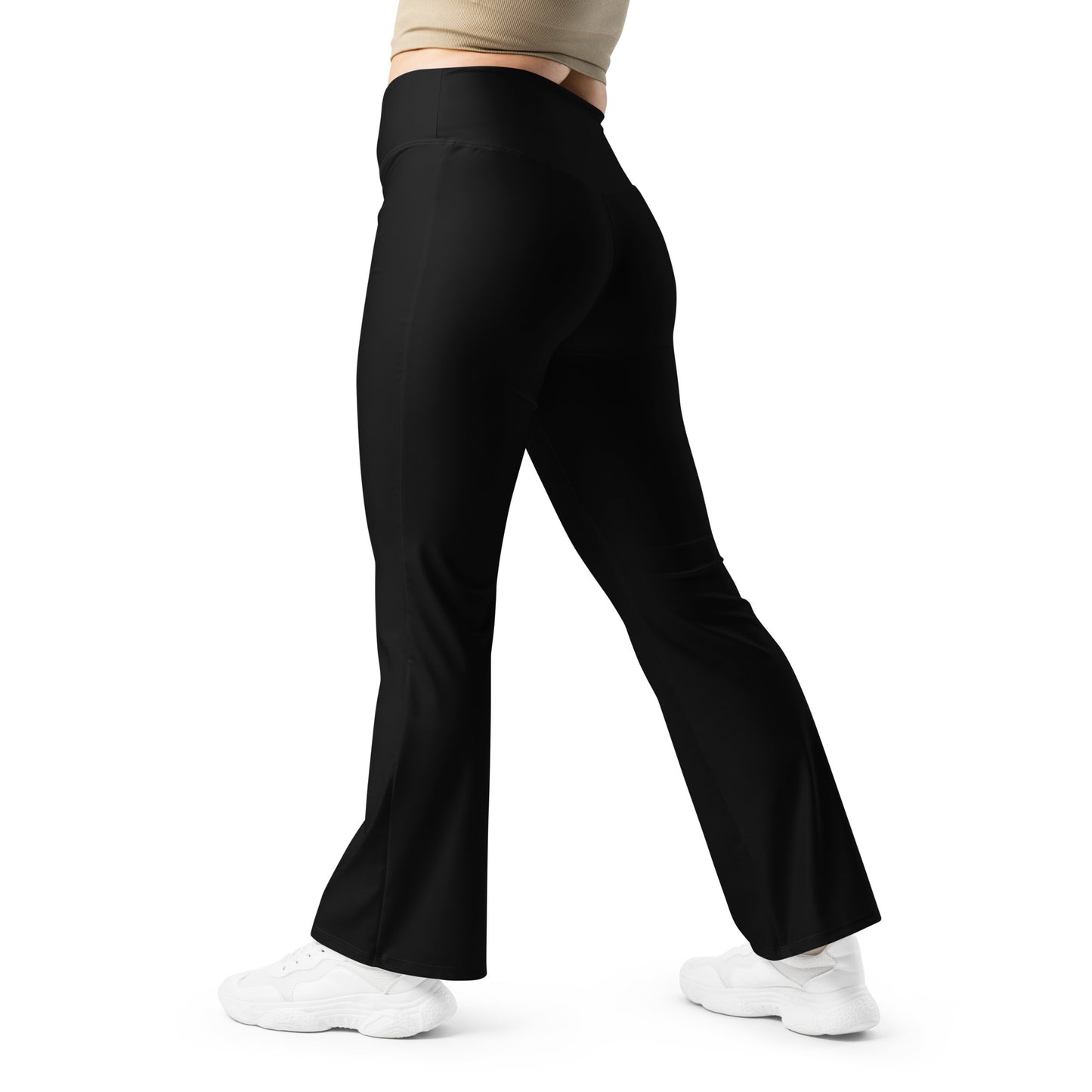 Person wearing black leggings paired with a beige crop top, white button-up jacket, and white sneakers—modern, stylish, and perfect for casual fashion.