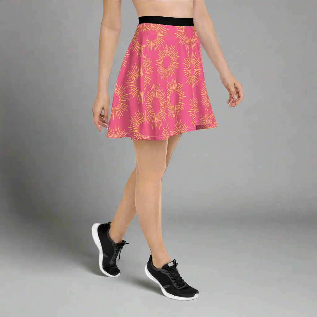 Pink skirt featuring a striking yellow sunburst pattern, paired with a black waistband and athletic shoes—bold, vibrant, and perfect for making a statement.