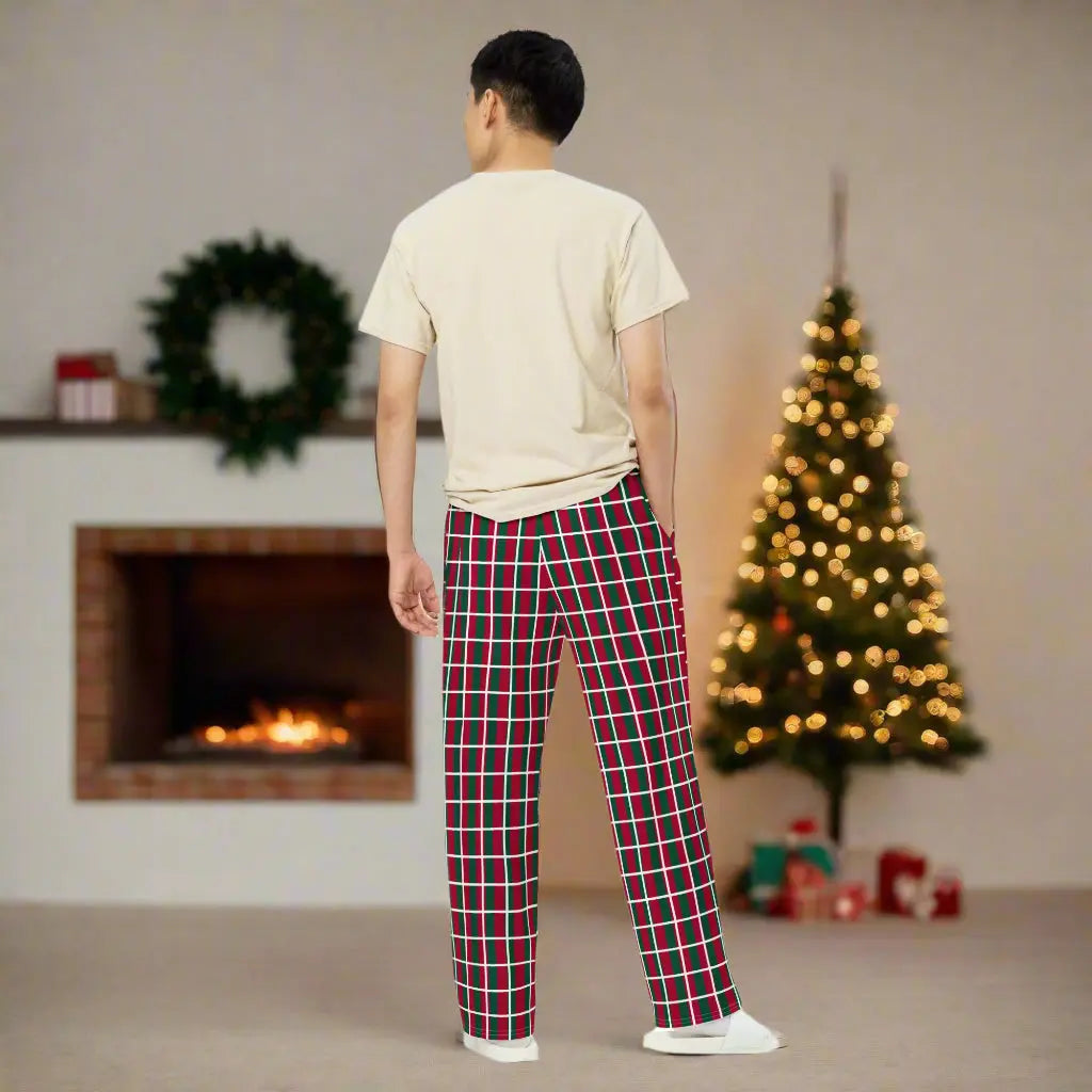 Person wearing red and green checkered Christmas pants, paired with a beige t-shirt and white shoes—festive, stylish, and perfect for holiday outfits.