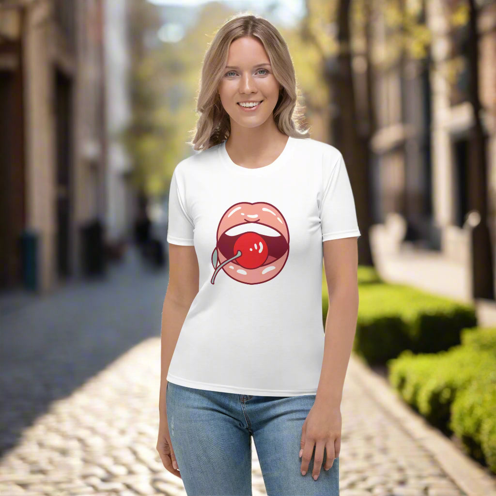 White t-shirt featuring a bold stylized lips and cherry graphic in red, paired with blue jeans—playful, stylish, and perfect for casual wear.