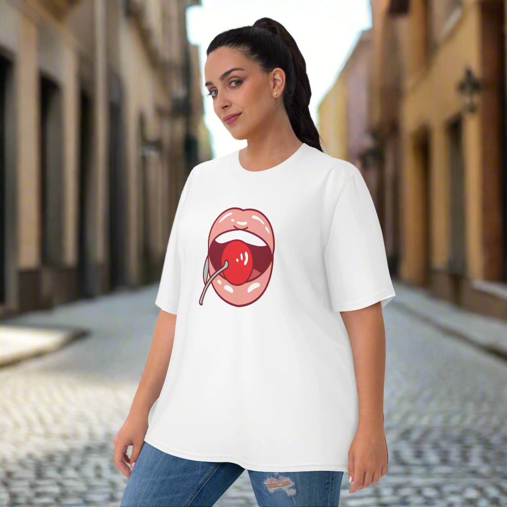 White t-shirt featuring a bold stylized lips and cherry graphic in red, paired with blue jeans—playful, stylish, and perfect for casual wear.