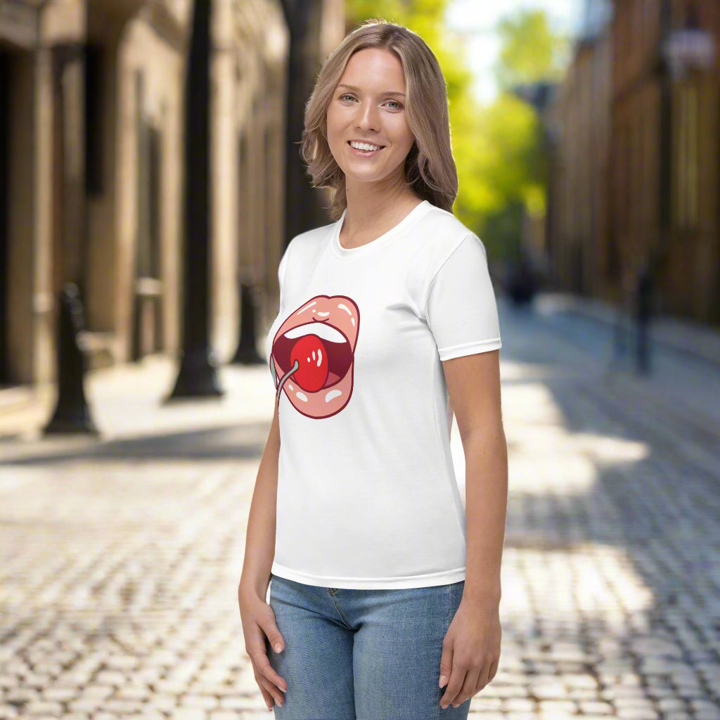 White t-shirt featuring a bold stylized lips and cherry graphic in red, paired with blue jeans—playful, stylish, and perfect for casual wear.