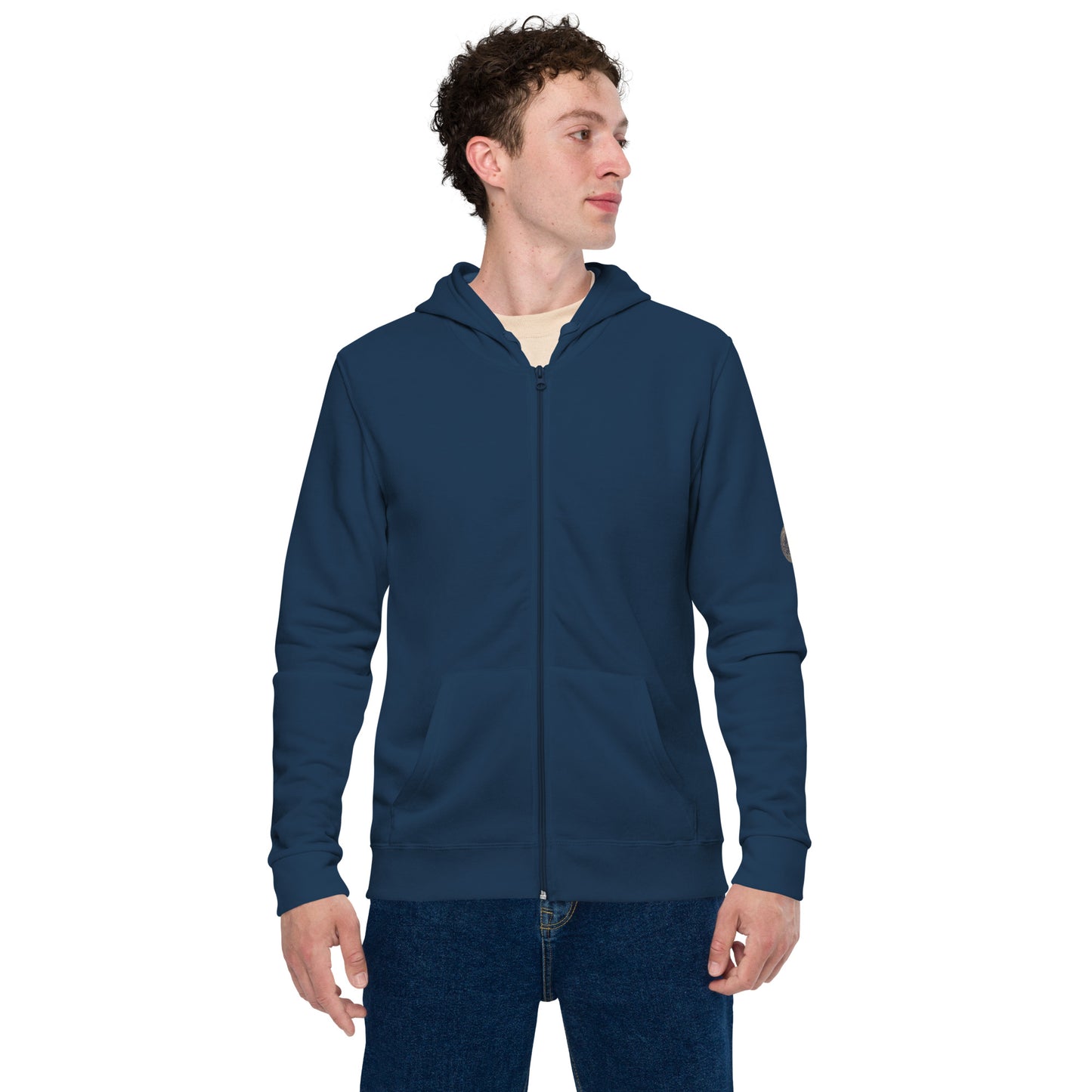 Person wearing a black zip-up hoodie featuring brushed fleece inside, kangaroo pockets, and a hood with matching drawstrings, paired with blue jeans—modern, comfortable, and perfect for athleisure styling.