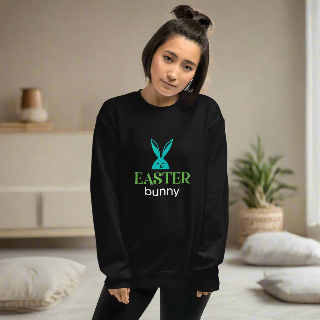 Black sweatshirt featuring a turquoise bunny head graphic with bold ‘EASTER bunny’ text—festive, stylish, and available in six colors excluding white.