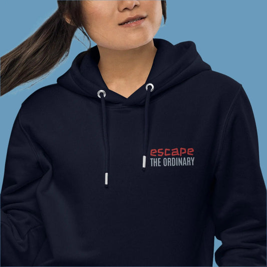 Minimalist street-style hoodie available in navy blue, black, and white, featuring a bold text design on the chest reading ‘escape’ in red and ‘THE ORDINARY’ in white, along with a front pocket and adjustable metal-tipped drawstring hood.