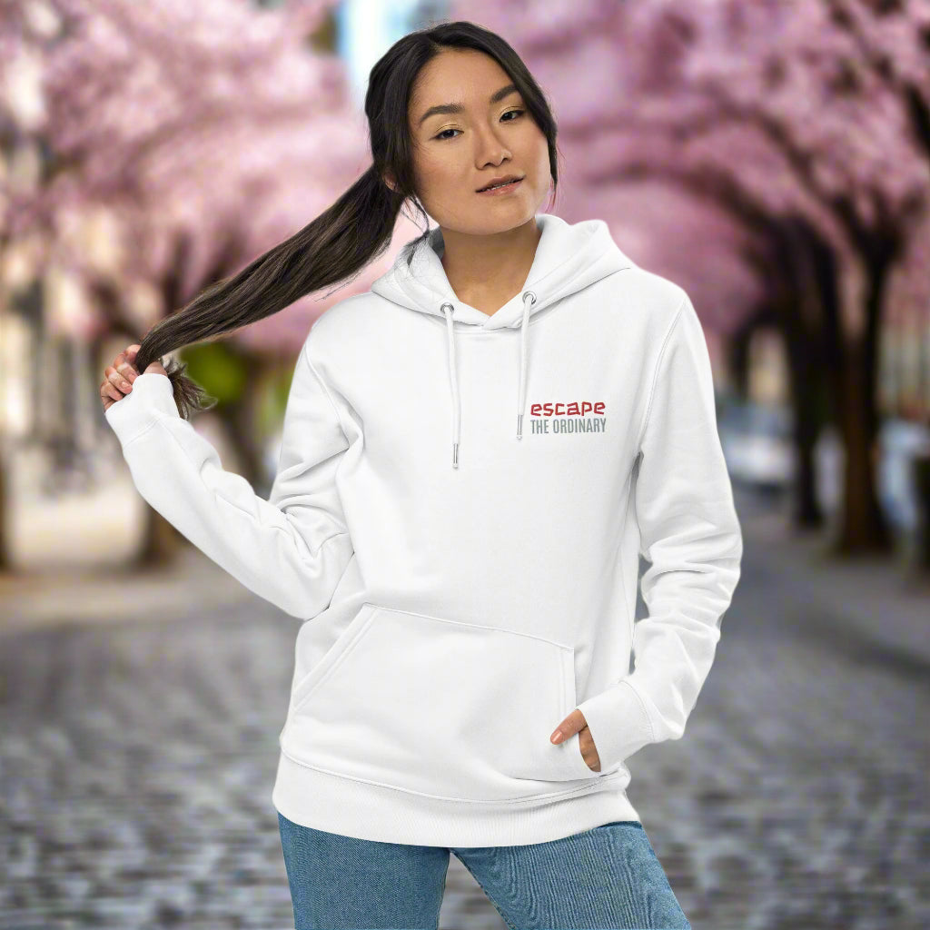 Minimalist street-style hoodie available in navy blue, black, and white, featuring a bold text design on the chest reading ‘escape’ in red and ‘THE ORDINARY’ in white, along with a front pocket and adjustable metal-tipped drawstring hood.