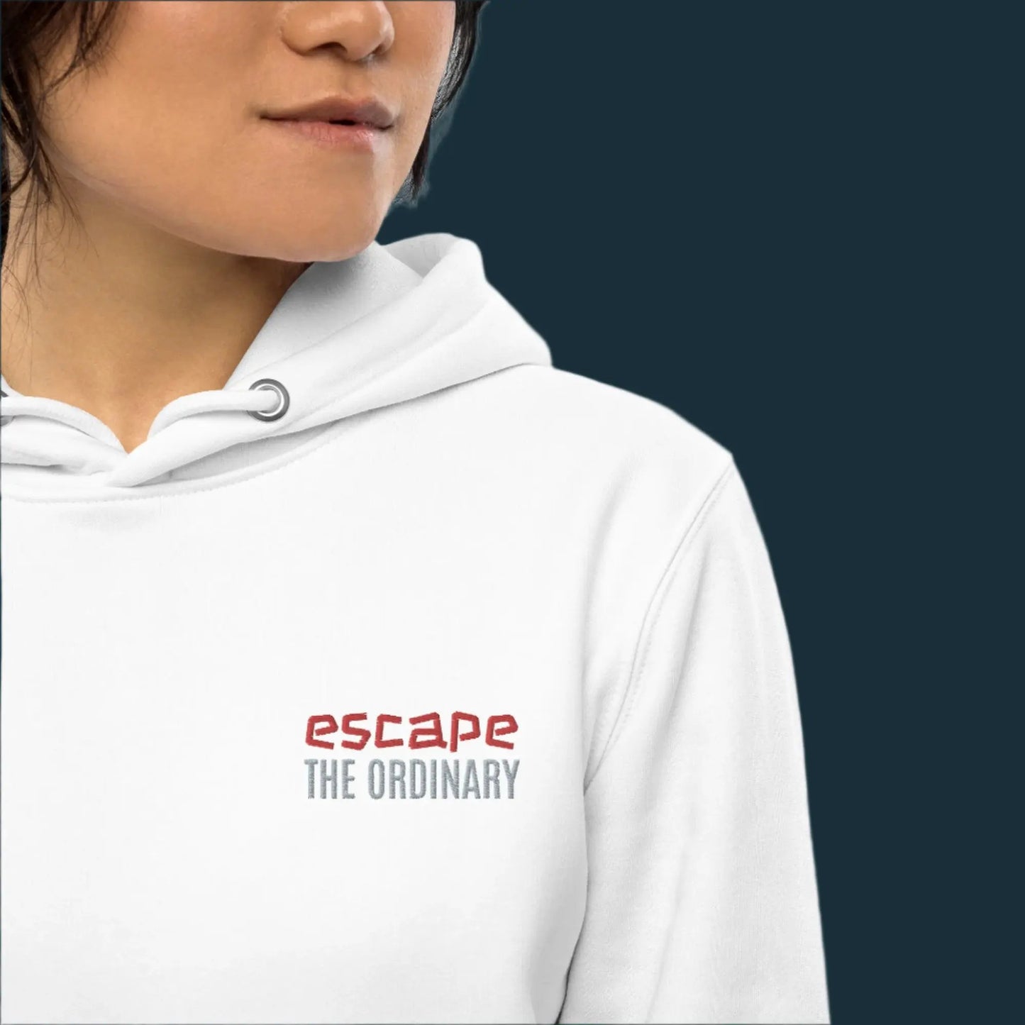 Minimalist street-style hoodie available in navy blue, black, and white, featuring a bold text design on the chest reading ‘escape’ in red and ‘THE ORDINARY’ in white, along with a front pocket and adjustable metal-tipped drawstring hood.