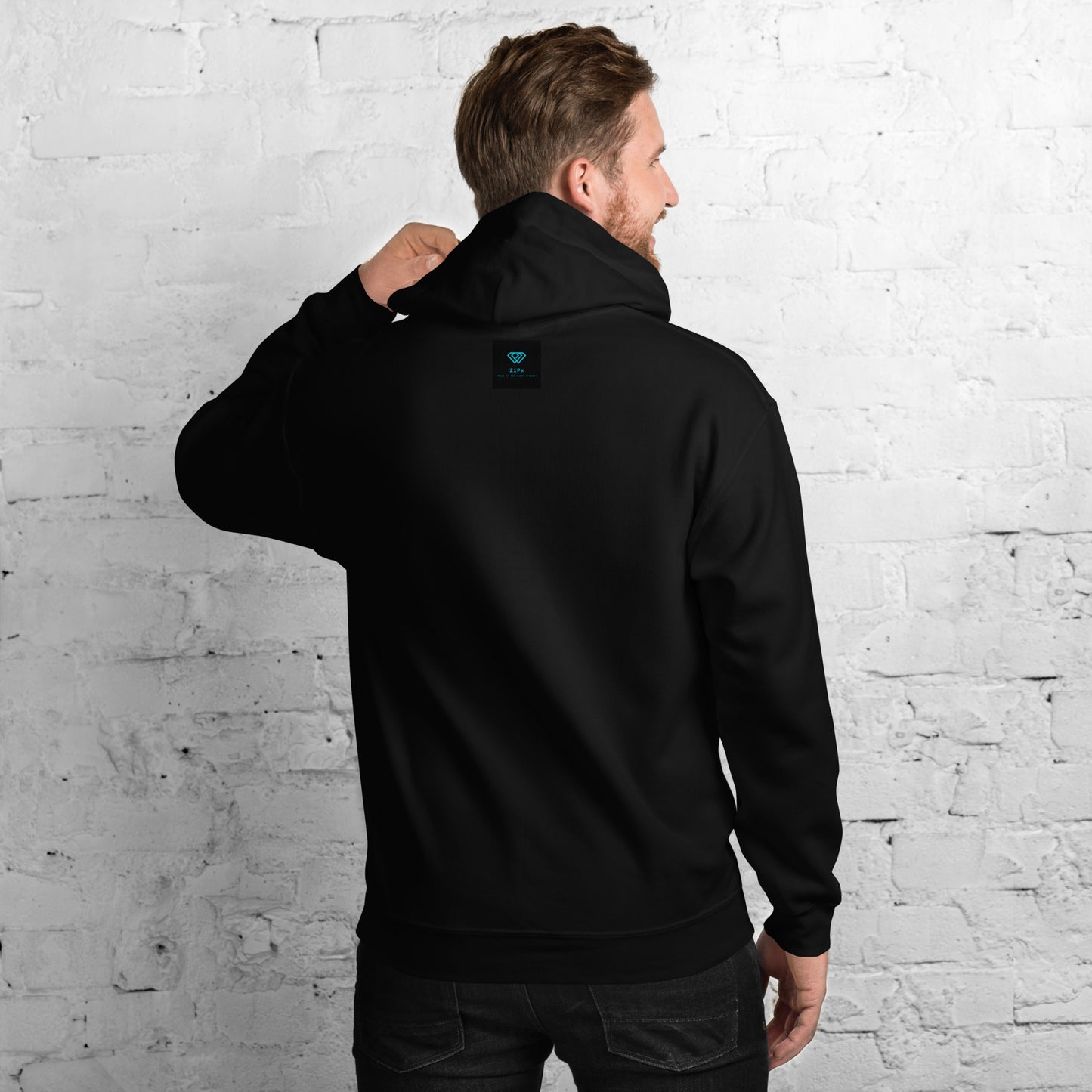 black hoodie featuring an embroidered letter ‘T’ on the left chest, worn against a white brick wall—modern, stylish, and available in Red, navy, and deep grey.
