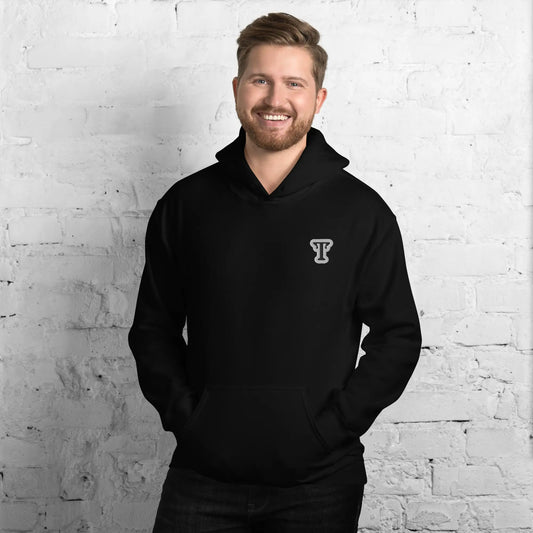 black hoodie featuring an embroidered letter ‘T’ on the left chest, worn against a white brick wall—modern, stylish, and available in Red, navy, and deep grey.