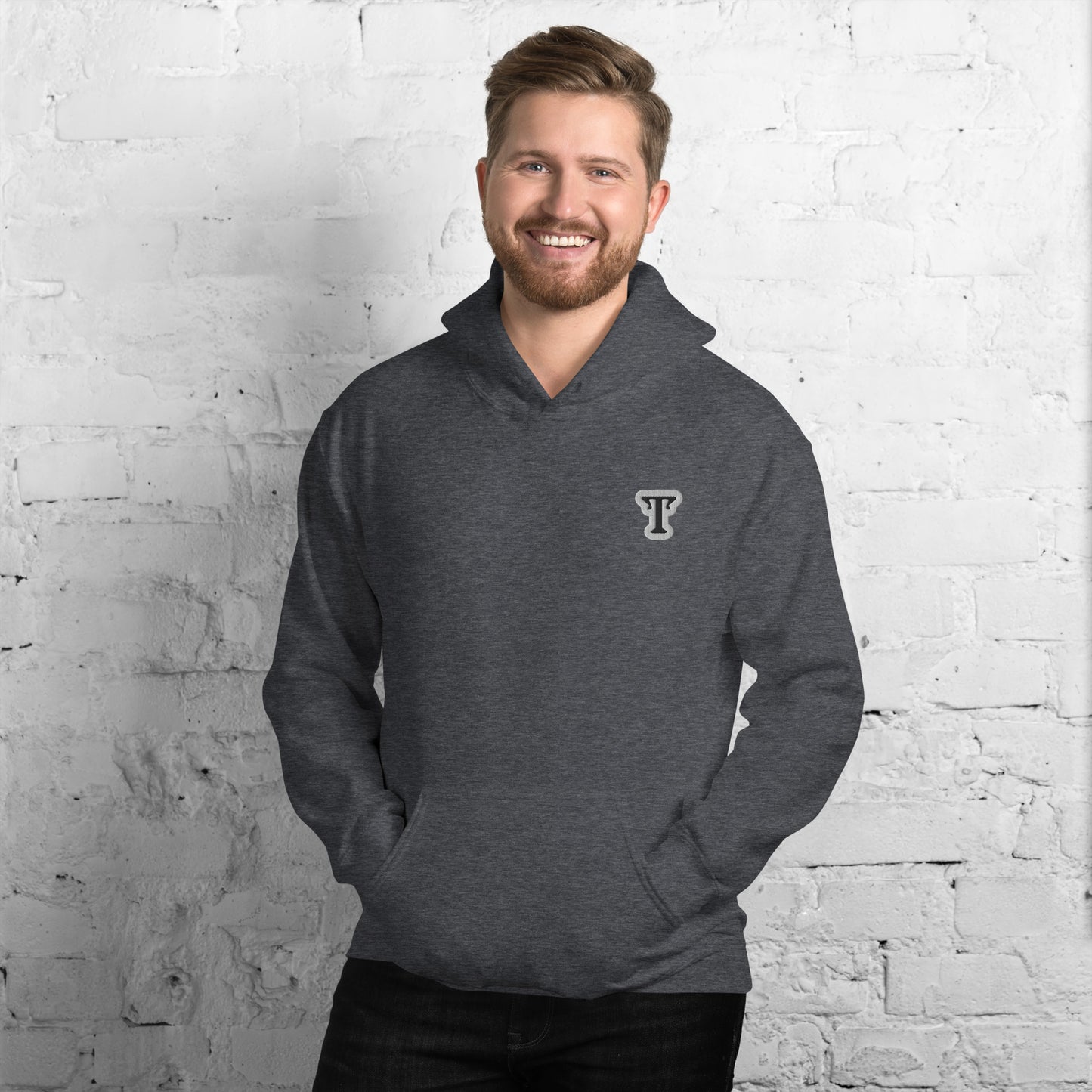 deep grey hoodie featuring an embroidered letter ‘T’ on the left chest, worn against a white brick wall—modern, stylish, and available in black, navy, and Red.