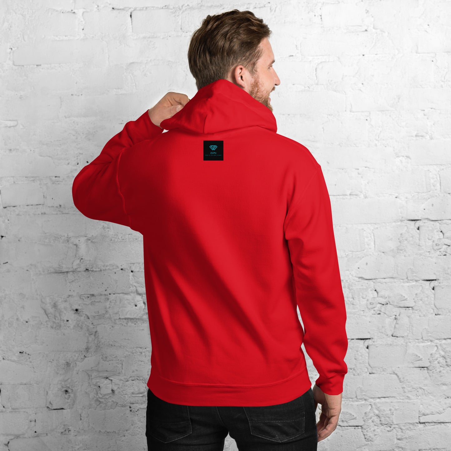 Red hoodie featuring an embroidered letter ‘T’ on the left chest, worn against a white brick wall—modern, stylish, and available in black, navy, and deep grey.
