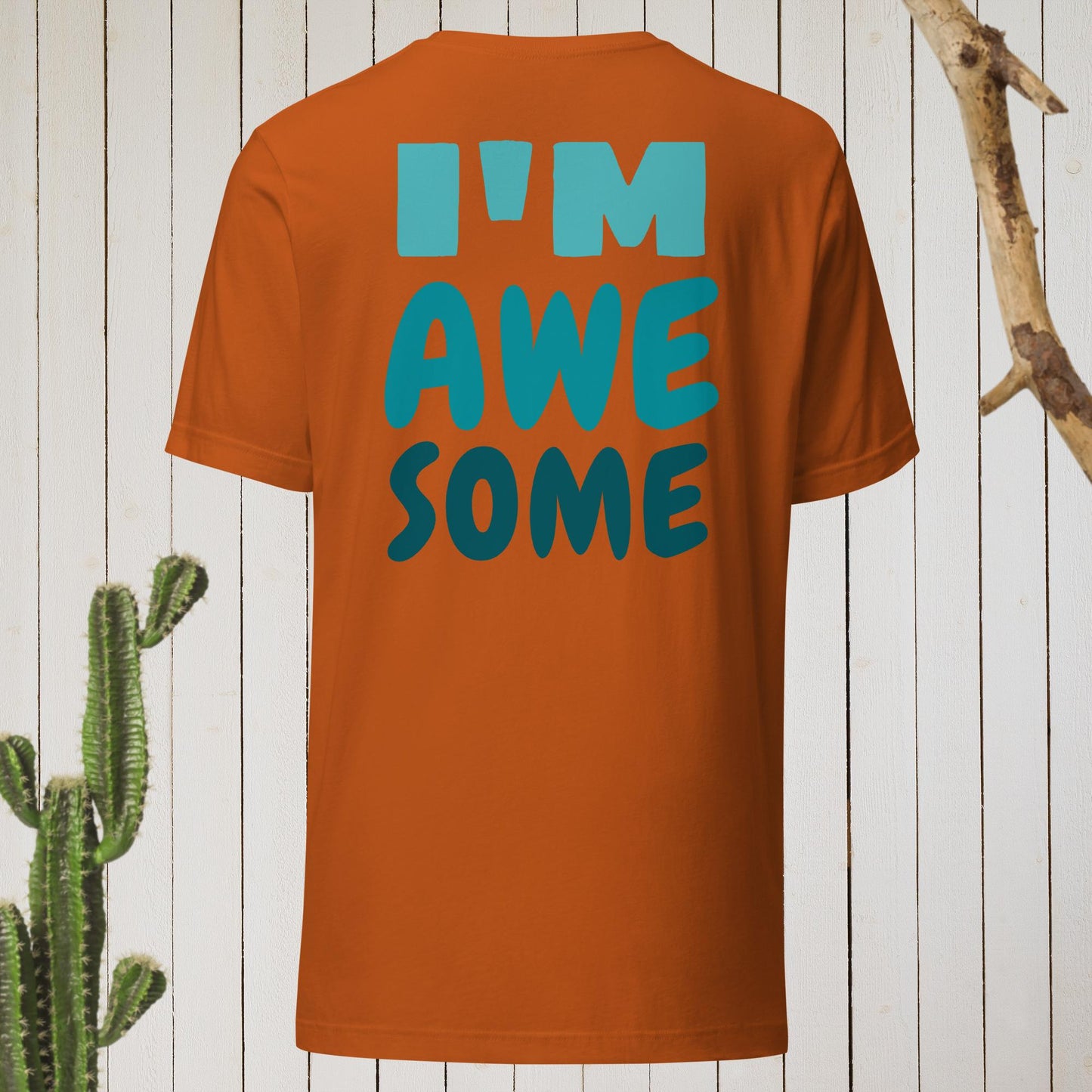 Dark gray t-shirt featuring a geometric bird design with a red head and teal-green body on the front, and bold blue text reading ‘I’M AWESOME’ on the back—stylish, artistic, and perfect for casual wear.