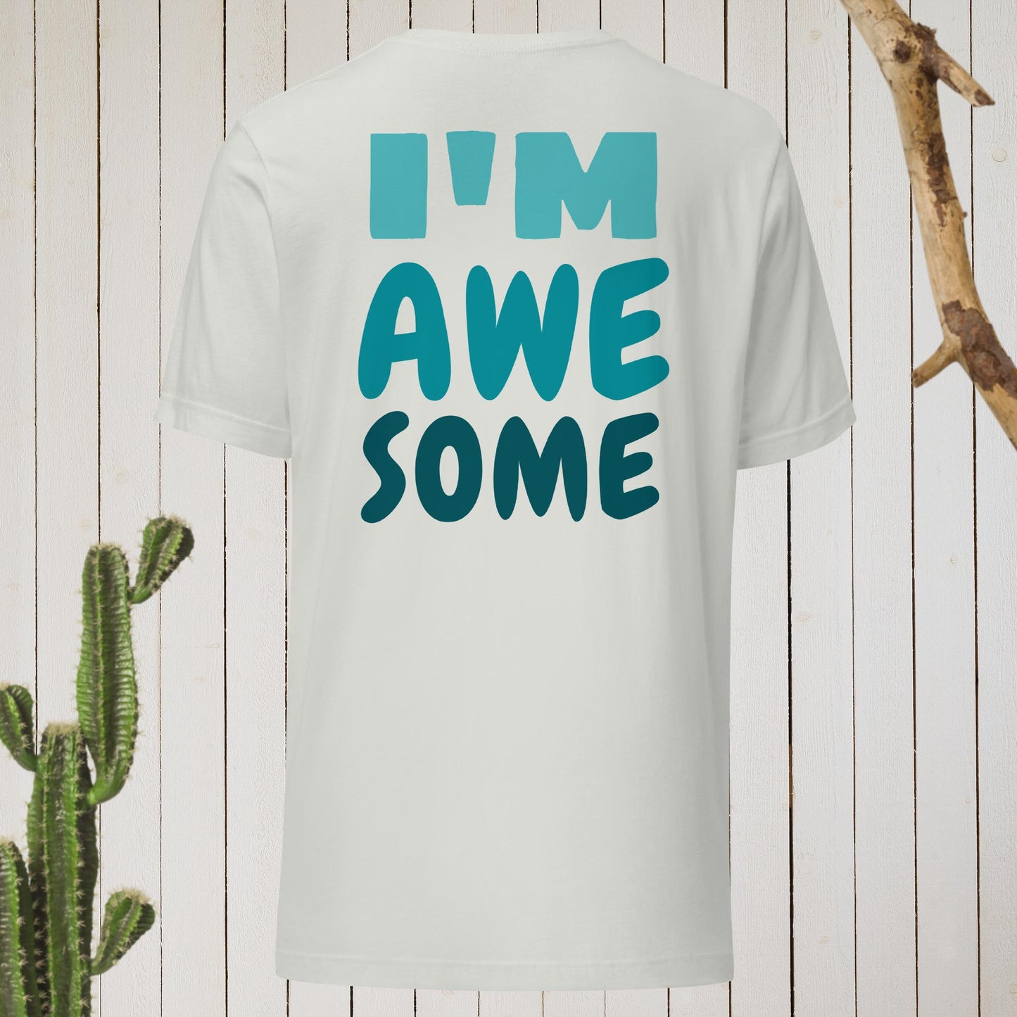 White t-shirt featuring a geometric bird design with a red head and teal-green body on the front, and bold blue text reading ‘I’M AWESOME’ on the back—stylish, artistic, and perfect for casual wear.