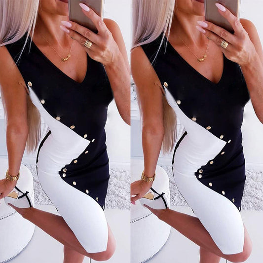 A stylish black-and-white dress with gold buttons, worn by a woman taking a mirror selfie. The dress features a V-neckline, structured fit, and elegant contrast design.