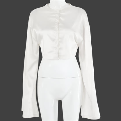 A model wearing a stylish two-piece set, featuring a high-waist tie skirt and a long-sleeved cardigan top, highlighting the flattering fit and elegant draping