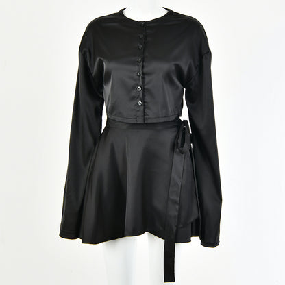 A model wearing a stylish two-piece set, featuring a high-waist tie skirt and a long-sleeved cardigan top, highlighting the flattering fit and elegant draping