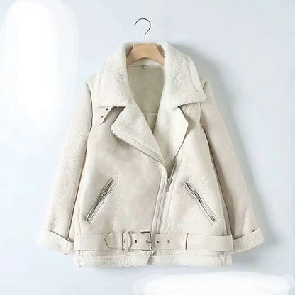 A cream-colored faux-shearling jacket with a wide collar, zippered front, and belt detail, hanging on a wooden hanger against a light gray background. 