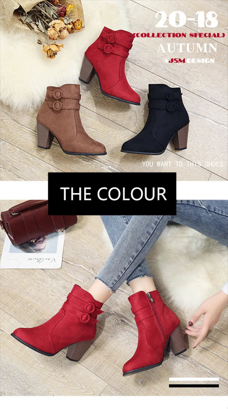 Red, brown, and black ankle boots on a wooden floor with a person wearing red boots.