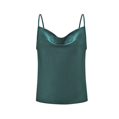 Green satin camisole top, styled with a light blue denim skirt, holding a branch with green leaves—modern, elegant, and perfect for casual or dressy looks.