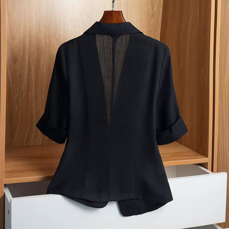 Black tailored blazer with a single-button closure, structured shoulders, front flap pockets, and rolled-up sleeves—modern, elegant, and perfect for office or casual styling.