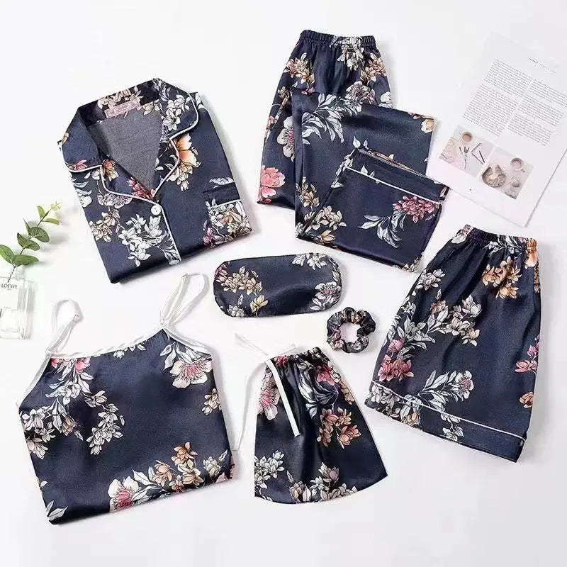 Luxury silk sleepwear set featuring a robe, nightgown, camisole, and long pants with delicate white lace trim—elegant, soft, and perfect for sleep and lounge.