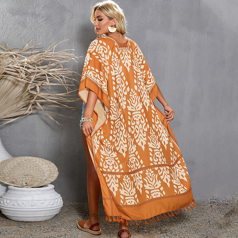 Rust-colored boho kimono-style cover-up with white intricate patterns and tassel detailing—lightweight, flowy, and perfect for summer layering.